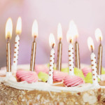 Plain candles and gold stars on a cake