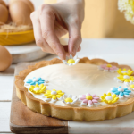 Spring tart decorated with light blue edible sugar flowers